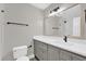 Modern bathroom featuring a gray vanity with white countertop, toilet, and black fixtures at 544 Orange Dr # 10, Altamonte Springs, FL 32701