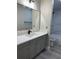 Bathroom featuring gray vanity, gray wood look flooring, white counter top and mirror at 544 Orange Dr # 10, Altamonte Springs, FL 32701