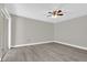 Light-filled bedroom with a ceiling fan, wood-look flooring, and a sliding glass door at 544 Orange Dr # 10, Altamonte Springs, FL 32701