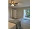 Bedroom featuring gray wood look flooring, ceiling fan, patio door and neutral colored walls at 544 Orange Dr # 10, Altamonte Springs, FL 32701