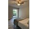 Bedroom featuring gray wood look flooring, ceiling fan, patio door and neutral colored walls at 544 Orange Dr # 10, Altamonte Springs, FL 32701