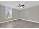 Well-lit bedroom featuring a ceiling fan, wood-look flooring, and a view from the window at 544 Orange Dr # 10, Altamonte Springs, FL 32701