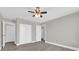 Neutral bedroom with white trim, ceiling fan and closet doors, and wood-look flooring at 544 Orange Dr # 10, Altamonte Springs, FL 32701