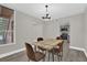 Open dining room with chandelier and natural light, adjacent to modern kitchen with stainless appliances at 544 Orange Dr # 10, Altamonte Springs, FL 32701