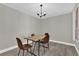 Inviting dining room with a contemporary chandelier and vinyl flooring ready for comfortable meals at 544 Orange Dr # 10, Altamonte Springs, FL 32701
