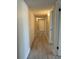 Hallway with closets and gray wood look flooring and neutral walls at 544 Orange Dr # 10, Altamonte Springs, FL 32701