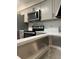 Updated kitchen with stainless steel appliances, quartz countertops, and modern fixtures at 544 Orange Dr # 10, Altamonte Springs, FL 32701