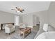 Bright living room boasts neutral tones, ceiling fan, and wood-look floors, offering a cozy feel at 544 Orange Dr # 10, Altamonte Springs, FL 32701