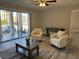 Bright living room with patio access, armchairs, and modern décor at 544 Orange Dr # 10, Altamonte Springs, FL 32701
