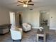 Open living room with desk, armchairs, and doorway to other rooms at 544 Orange Dr # 10, Altamonte Springs, FL 32701