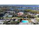 Aerial view showcasing the community's pool, tennis courts, surrounding lake, and lush landscaping at 6258 Masters Blvd # C204, Orlando, FL 32819