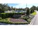 Bay Hill Club & Lodge entrance featuring manicured landscaping, stone signage, and ample parking at 6258 Masters Blvd # C204, Orlando, FL 32819