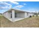 Exterior view of patio and backyard with lawn and a full fence at 2107 Riley Ave, Eagle Lake, FL 33839
