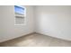 This is a simple bedroom with carpet and a large window at 2107 Riley Ave, Eagle Lake, FL 33839