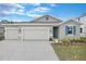 Charming single-story home with a two-car garage and a meticulously maintained front yard at 2107 Riley Ave, Eagle Lake, FL 33839