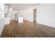 Open living space with wood-look floors seamlessly connecting the kitchen to a bright, airy area at 2107 Riley Ave, Eagle Lake, FL 33839