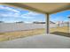 Covered patio overlooking fenced backyard, offering a peaceful outdoor living space at 2107 Riley Ave, Eagle Lake, FL 33839