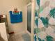 Bright bathroom featuring a glass-enclosed shower and towel rack with colorful blue and orange towels at 2109 Woodsedge Dr, Kissimmee, FL 34746
