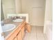 Well-lit bathroom with double sinks, tile floors, and ample storage space at 2109 Woodsedge Dr, Kissimmee, FL 34746