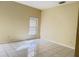 A bright empty bedroom with tile floors and a large window at 2109 Woodsedge Dr, Kissimmee, FL 34746