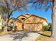 Charming single Gathering home with a well-manicured lawn and a two-car garage at 2109 Woodsedge Dr, Kissimmee, FL 34746