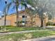 A single-Gathering home has a 2-car garage, lush green landscaping and mature trees at 2109 Woodsedge Dr, Kissimmee, FL 34746