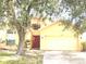 Charming single-Gathering home with a well-manicured lawn and a cozy front porch at 2109 Woodsedge Dr, Kissimmee, FL 34746