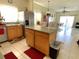 Bright kitchen featuring stainless steel appliances, tile floor, and island with breakfast bar at 2109 Woodsedge Dr, Kissimmee, FL 34746