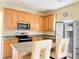 Well-equipped kitchen with stainless steel appliances and light wood cabinetry at 2109 Woodsedge Dr, Kissimmee, FL 34746
