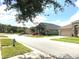 Charming street view showcasing well-maintained homes and lush landscaping, creating a welcoming neighborhood feel at 2109 Woodsedge Dr, Kissimmee, FL 34746