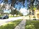 A quiet residential street with tree-lined sidewalks and well-maintained lawns at 2109 Woodsedge Dr, Kissimmee, FL 34746