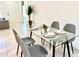 Glass dining table with four chairs in a bright dining area at 6809 149Th Lane Rd, Ocala, FL 34473
