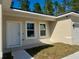 House exterior showcasing a white front door and windows at 6809 149Th Lane Rd, Ocala, FL 34473