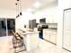 Open concept kitchen with white cabinets and breakfast bar at 6809 149Th Lane Rd, Ocala, FL 34473