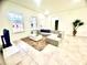 Bright living room with L-shaped sofa and large windows at 6809 149Th Lane Rd, Ocala, FL 34473