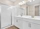 Bathroom featuring double sinks, quartz countertops, and a glass-enclosed walk-in shower at 814 Ballantyne Dr, Lake Wales, FL 33898
