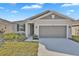 Charming single-story home featuring a two-car garage and well-maintained front yard at 814 Ballantyne Dr, Lake Wales, FL 33898