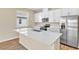 Modern kitchen features stainless steel appliances and an island with a sink at 814 Ballantyne Dr, Lake Wales, FL 33898
