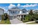 Charming two-story home with a paver driveway, an attached two-car garage, and a beautifully landscaped front yard at 11843 Imaginary Way, Orlando, FL 32832