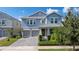 Charming two-story home with an attached two-car garage, landscaped front yard, and covered porch at 11843 Imaginary Way, Orlando, FL 32832