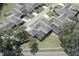 Overhead view of a community showcasing homes with screened-in patios, lush trees, and well-kept landscapes at 1493 Magellan Cir # 504, Orlando, FL 32818