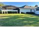 Sprawling backyard with lush green lawn and mature landscaping provides privacy at 1493 Magellan Cir # 504, Orlando, FL 32818