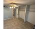 A bright bedroom has tile floors, a ceiling fan, and a walk-in closet at 1493 Magellan Cir # 504, Orlando, FL 32818