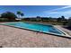 The community pool is surrounded by lush landscaping, creating a private oasis at 1493 Magellan Cir # 504, Orlando, FL 32818