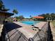 Community pool with umbrellas and brick pavers, ideal for hot summer days at 1493 Magellan Cir # 504, Orlando, FL 32818