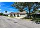 Attractive single story home with an attached garage shaded by a mature tree and a well manicured lawn at 1493 Magellan Cir # 504, Orlando, FL 32818