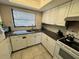 Modern kitchen featuring white cabinets, updated appliances, and a bright window at 1493 Magellan Cir # 504, Orlando, FL 32818