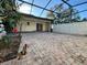 Spacious brick patio with a screened enclosure, perfect for outdoor entertaining and relaxation at 1493 Magellan Cir # 504, Orlando, FL 32818