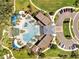 Stunning aerial view of community pool, cabanas, clubhouse and parking area in a well landscaped community at 2505 Dharma Cir, Kissimmee, FL 34746