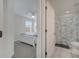View into bedroom and attached bathroom with white cabinets and leafy shower curtain at 2505 Dharma Cir, Kissimmee, FL 34746
